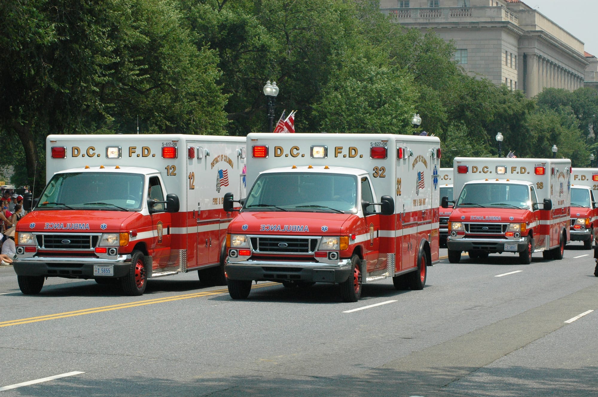 Ambulances drive down a major street in D.C.