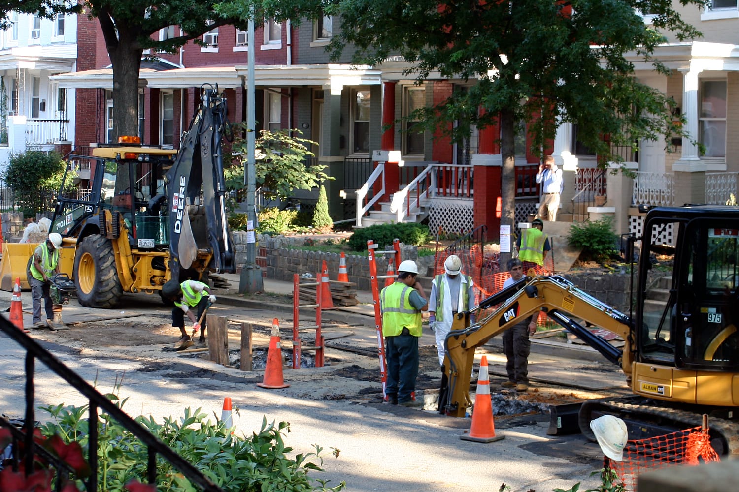  A picture of construction workers digging up lead pipes with large machinery.