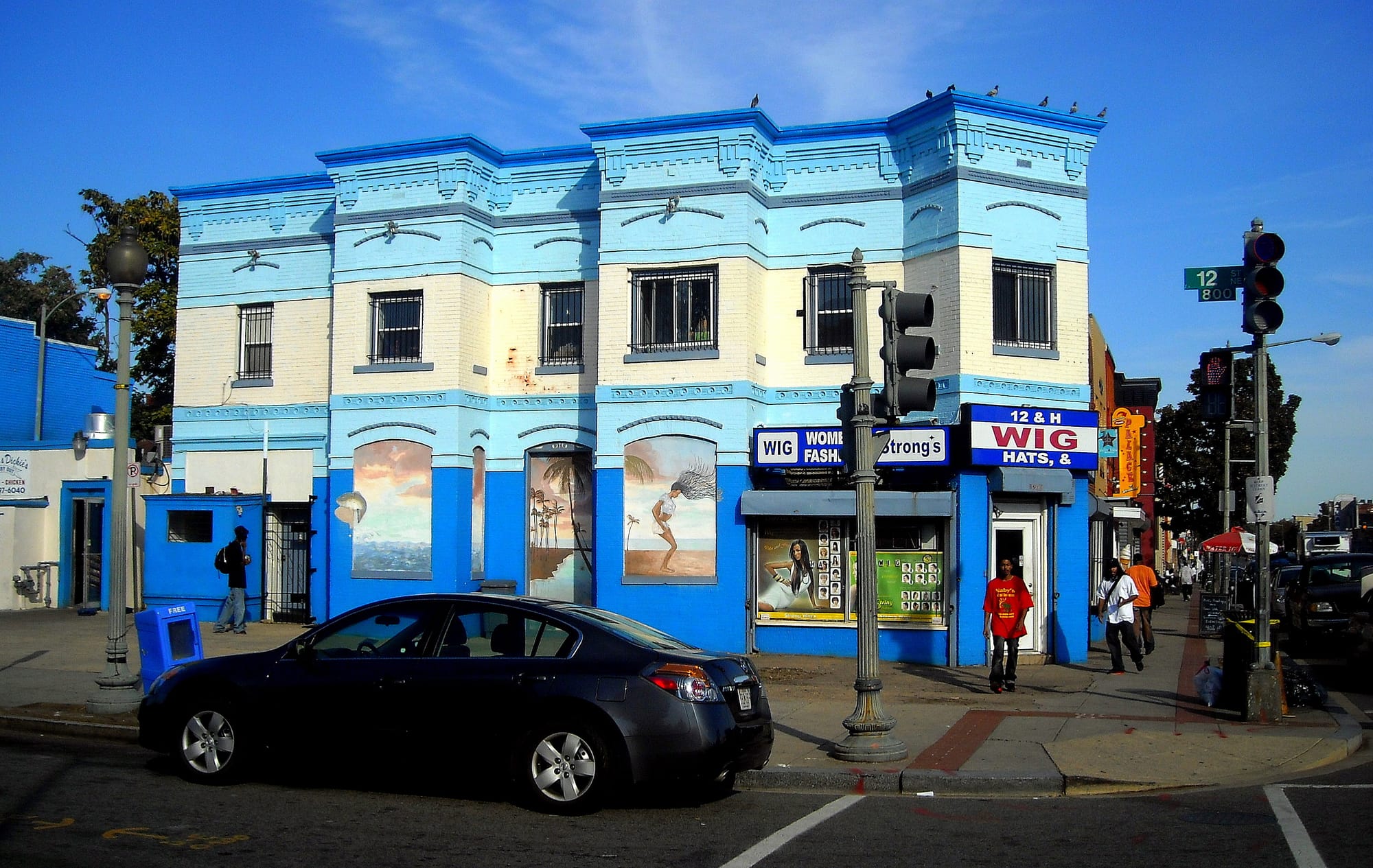 A photo of a wig store in an blue building on a street corner in Washington D.C.'s Trinidad neighborhood. 