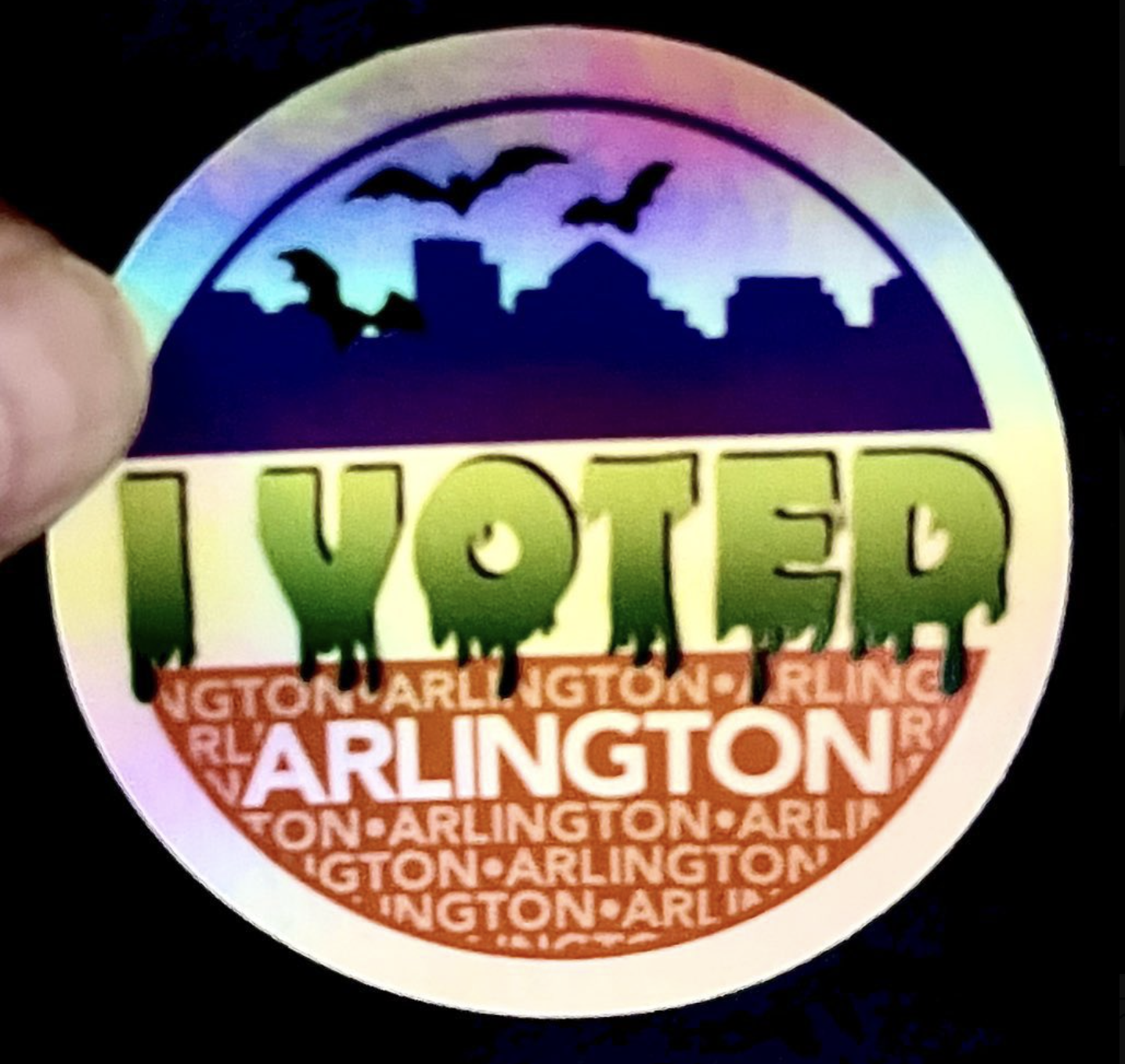 Arlington's spooky I voted sticker, with bats flying around a Rosslyn skyline and "I voted" written in gooey green font