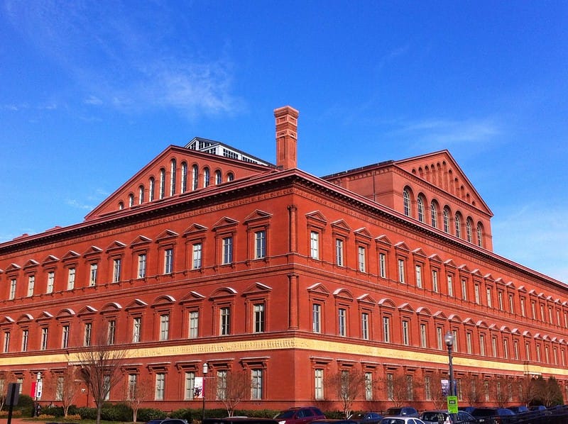 The exterior of a large, red brick building. 