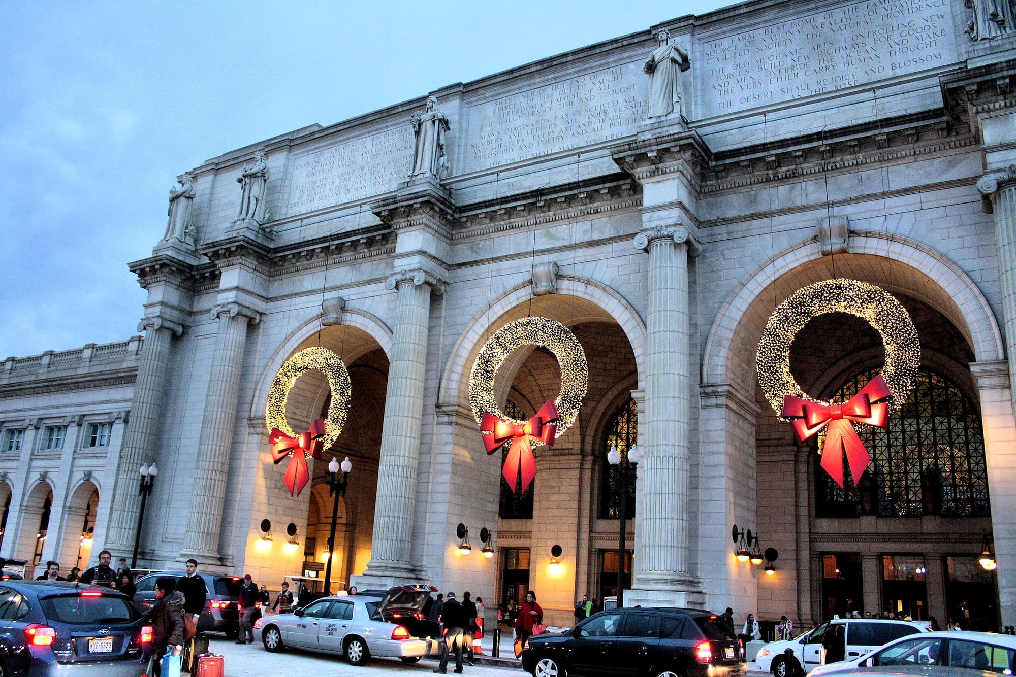 Three large and lit-up wreaths pictured in the archways at the entrance to Union Station.