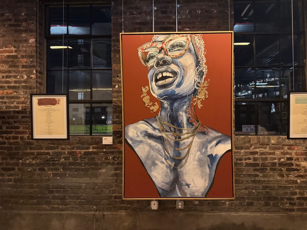 A portrait of a Black woman hung up in an industrial space. She has ornate glasses, earrings, and a necklace. 