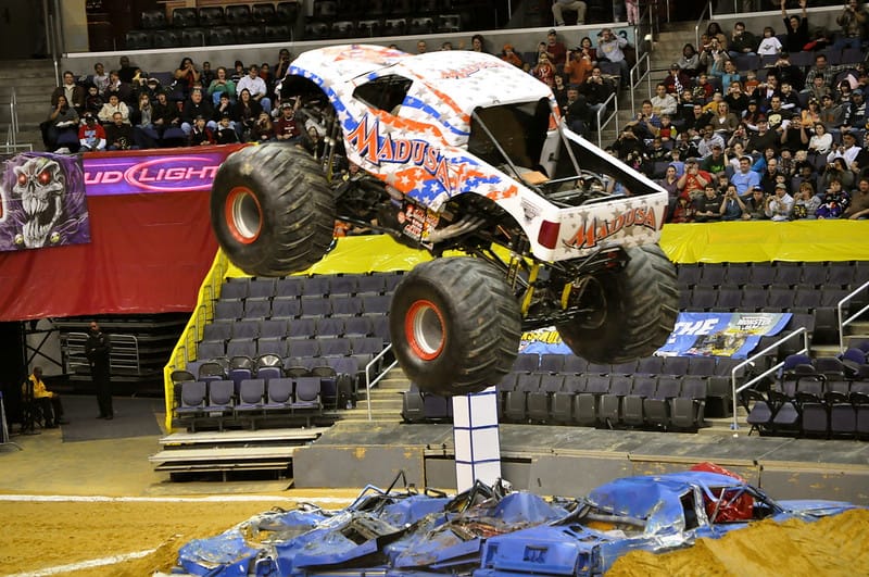 Photo of white, blue, and red monster truck in the air.