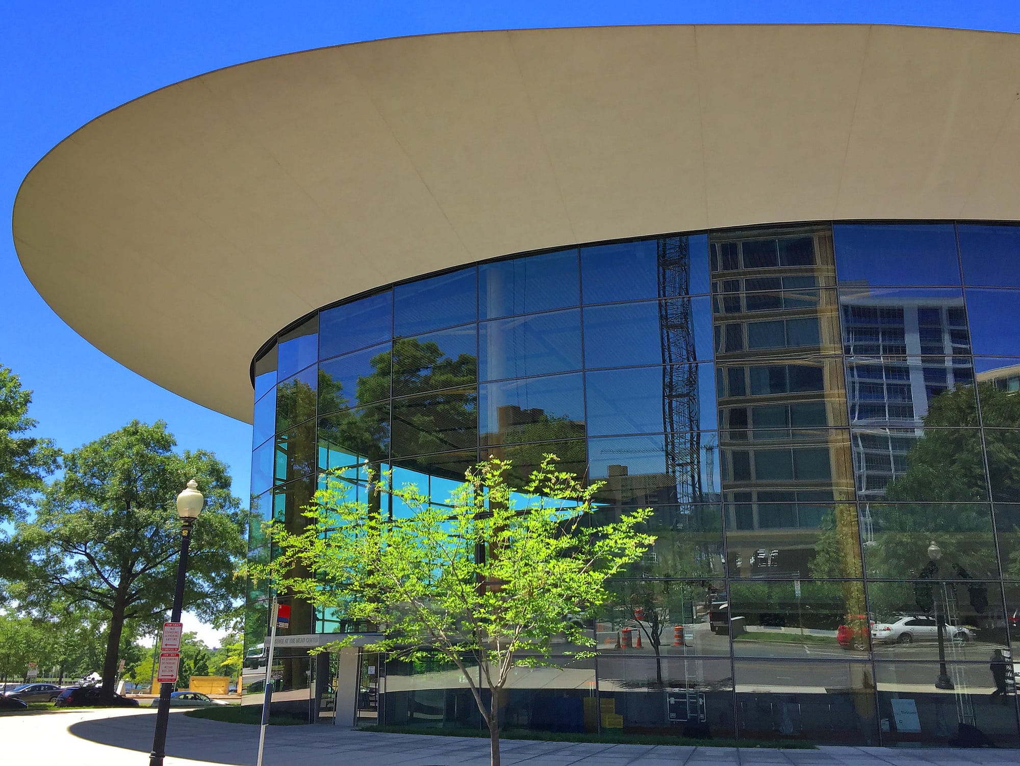 A view of the outside of Arena Stage with a tree in the foreground