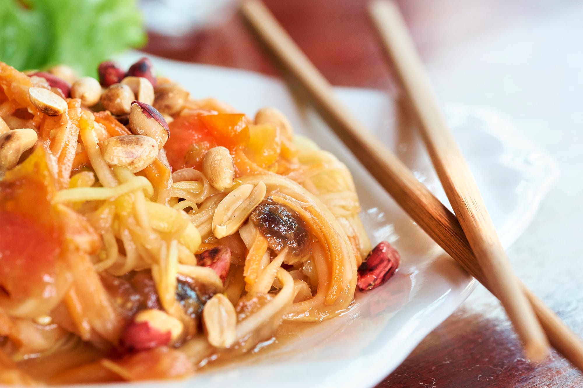 A zoomed-in frame shows a pile of pad Thai with two chopsticks. 