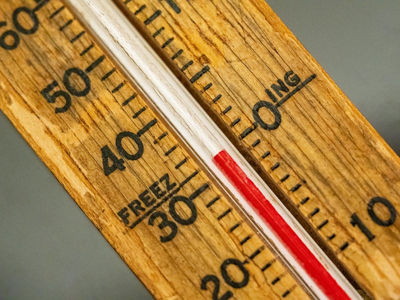 A thermometer reads a freezing temperature. 