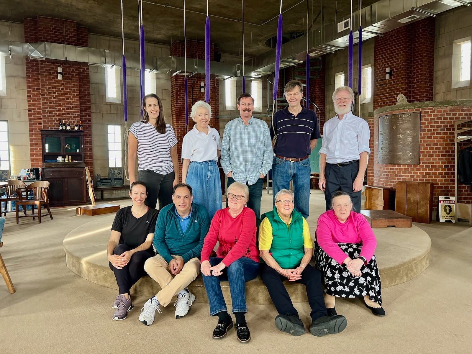 A group of ringers pose for a photo in the ringing chamber at the National Cathedral.