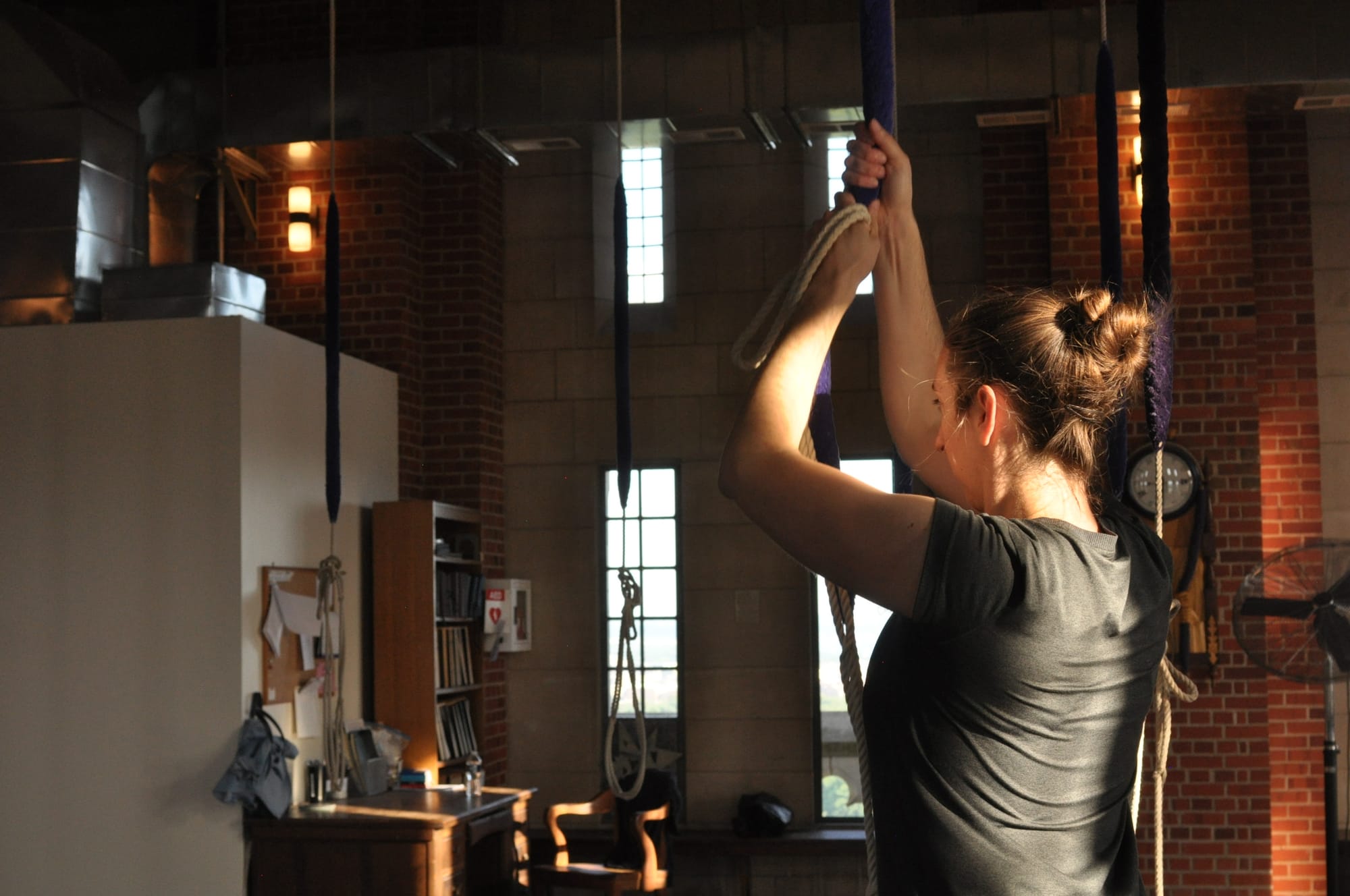 A woman pulls on a bell ringing rope in the ringing chamber at the National Cathedral.