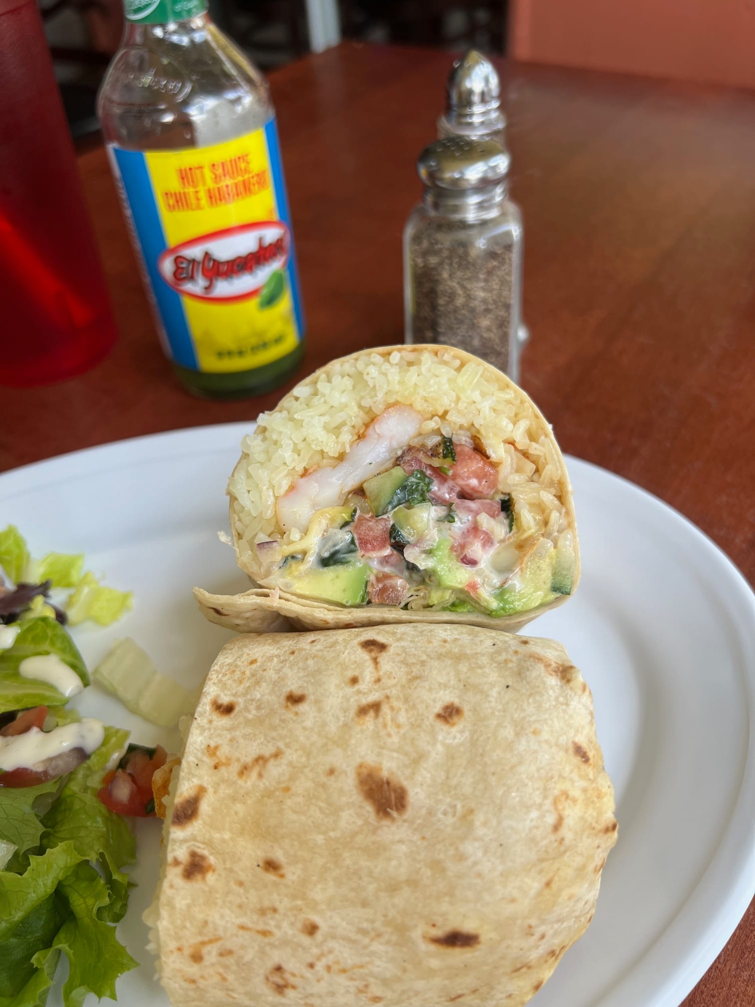 An image of a burrito sliced in half. 