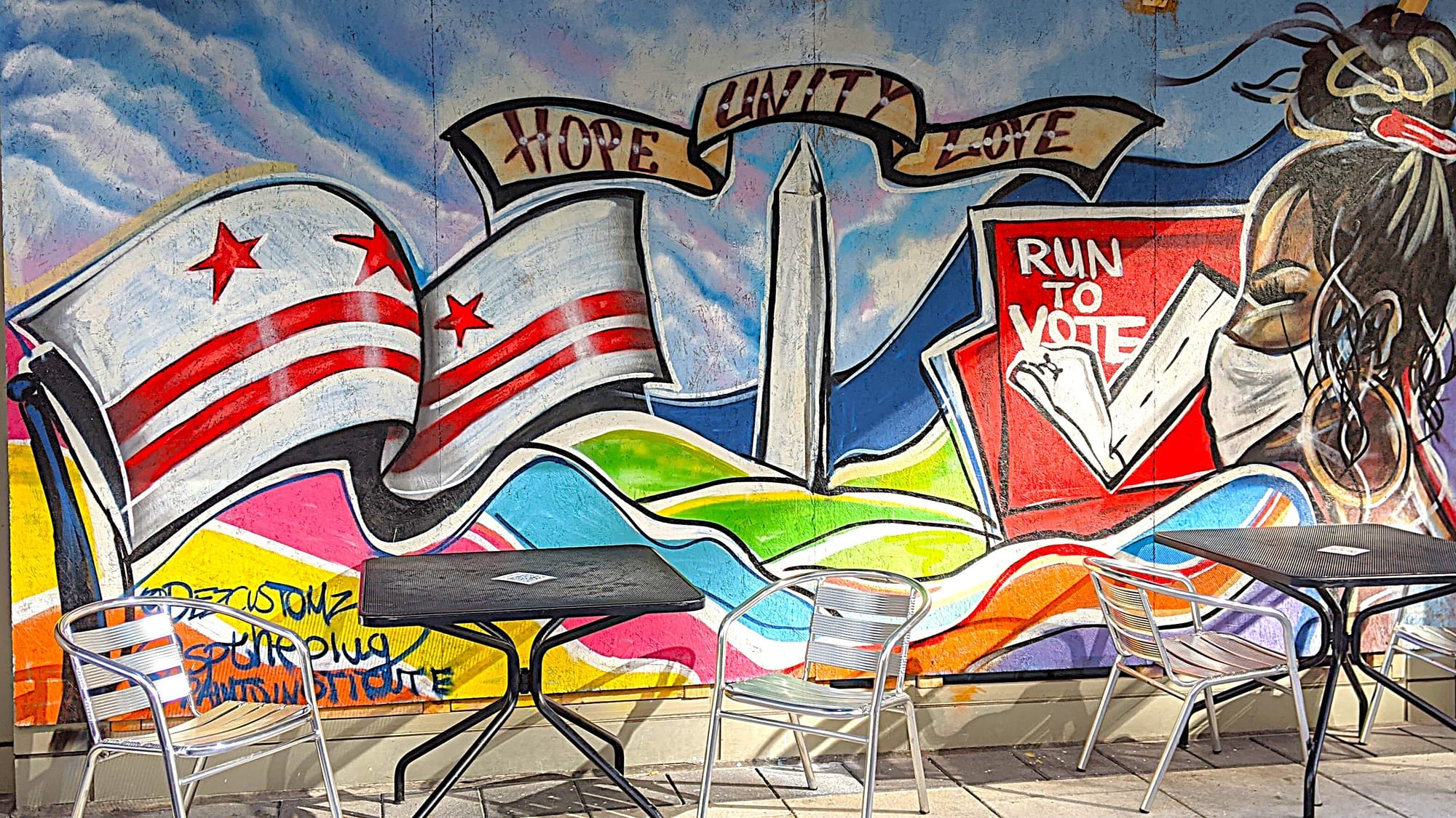 A mural with a D.C. flag, a rainbow flag, and a banner that reads: "Hope, Unity, Love."