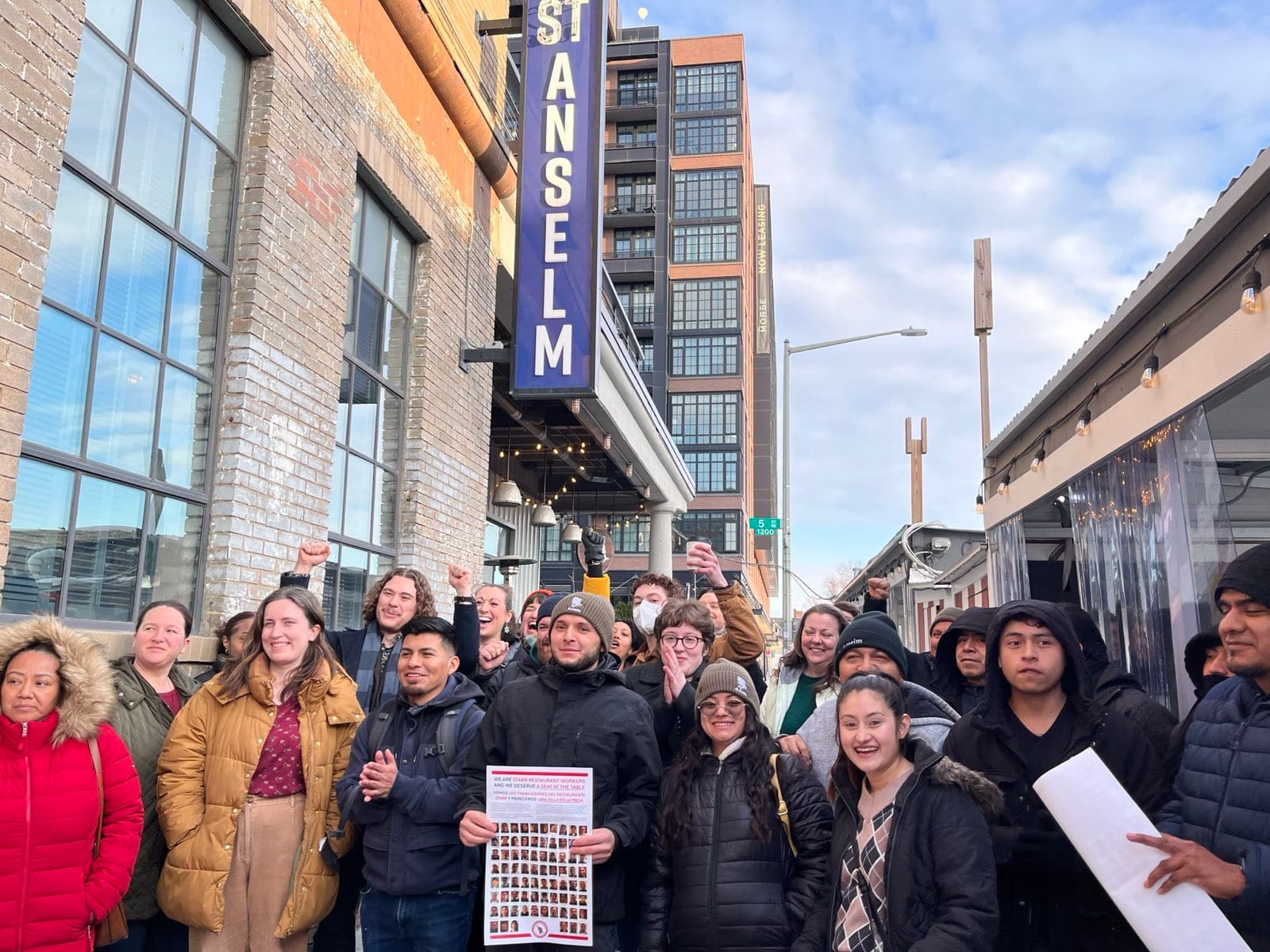 A large group of restaurant workers pictured outside their restaurant, St. Anselm.