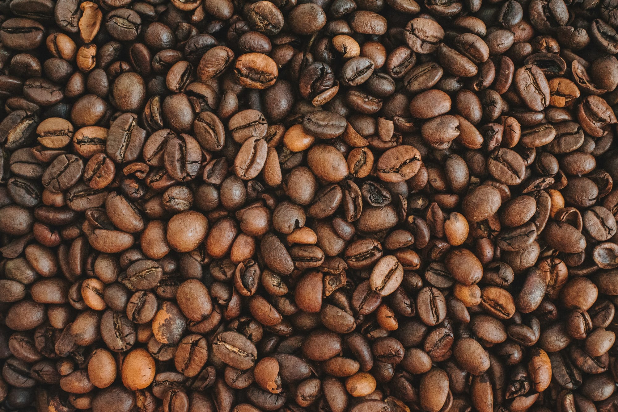 A zoomed in shot of brown coffee beans. 