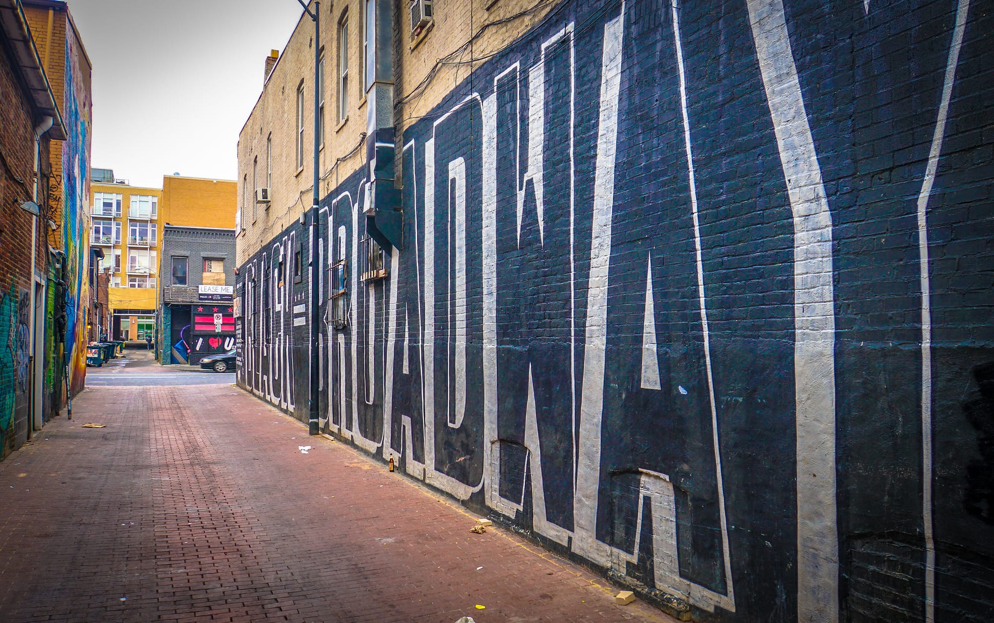 A mural reads Black Broadway in large Black letters. 