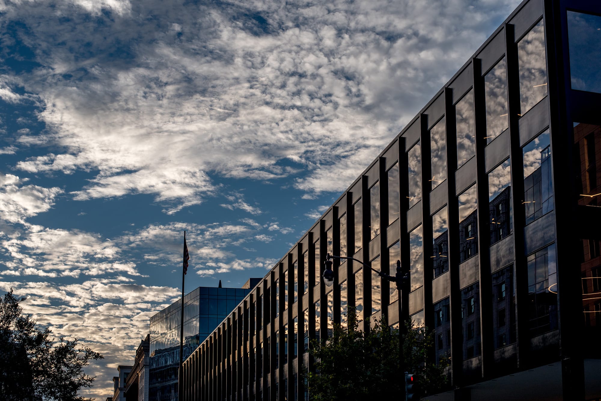 The side of MLK Library at sunset, reflecting clouds. 