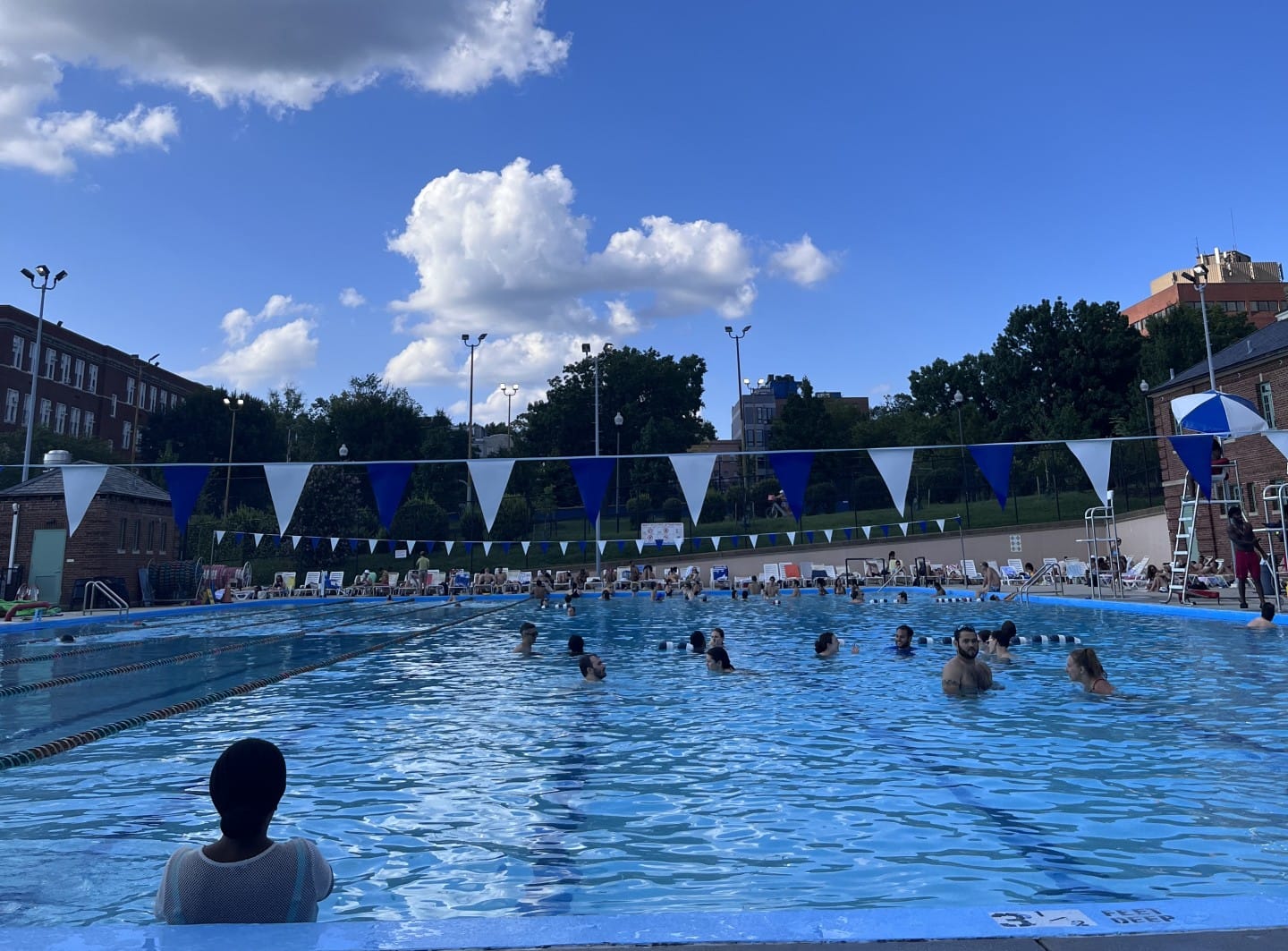 A public pool filled with people.