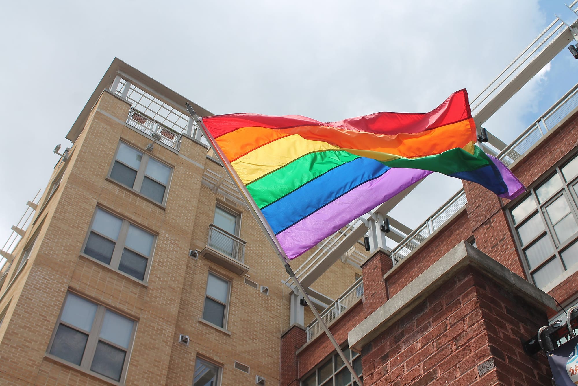A pride flag waves in front of buildings on D.C.'s U Street NW.