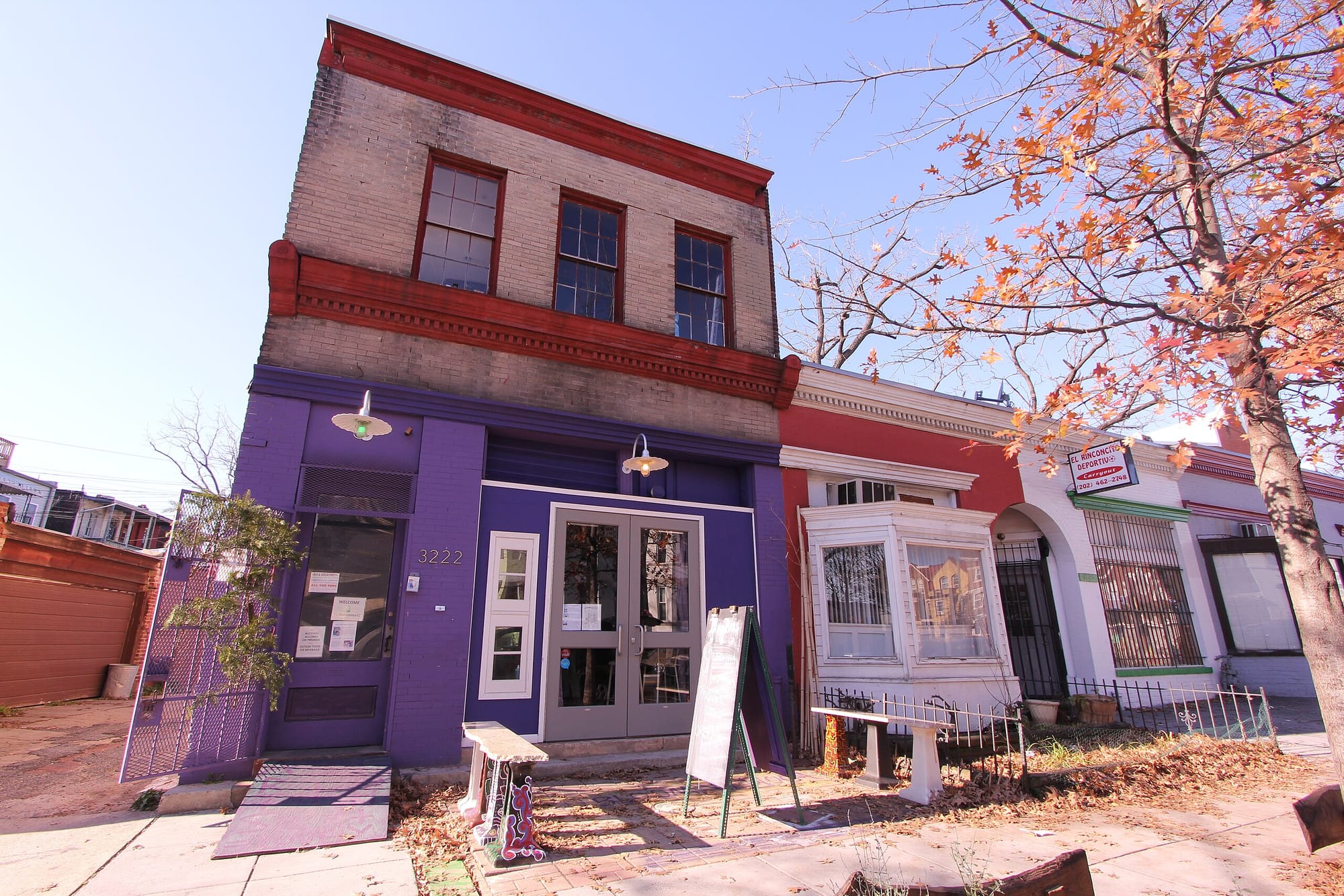 A block of buildings in D.C. in the autumn, featuring BloomBars, a local venue.