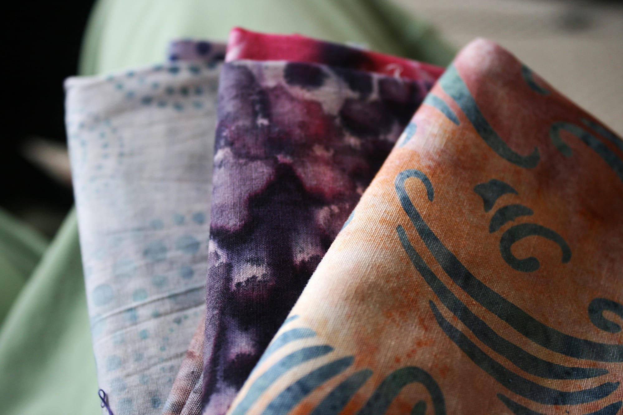 Three pieces of folded, colorful fabric.