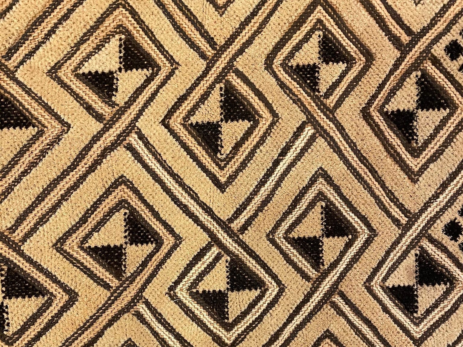 A woven black and tan textile