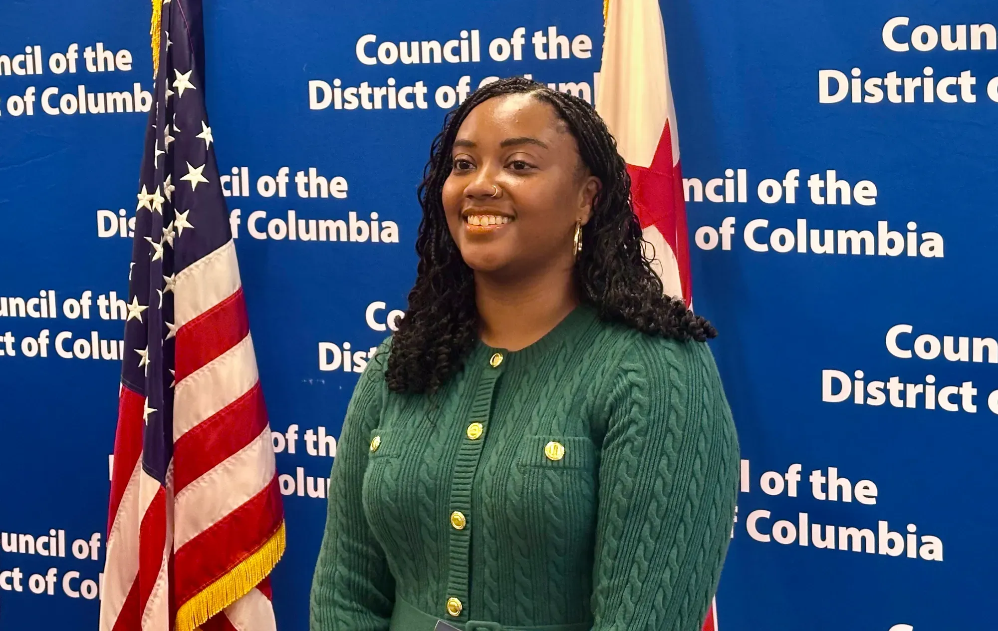 A photograph of Doni Crawford next to an American flag with a blue background that reads: "District of Columbia"