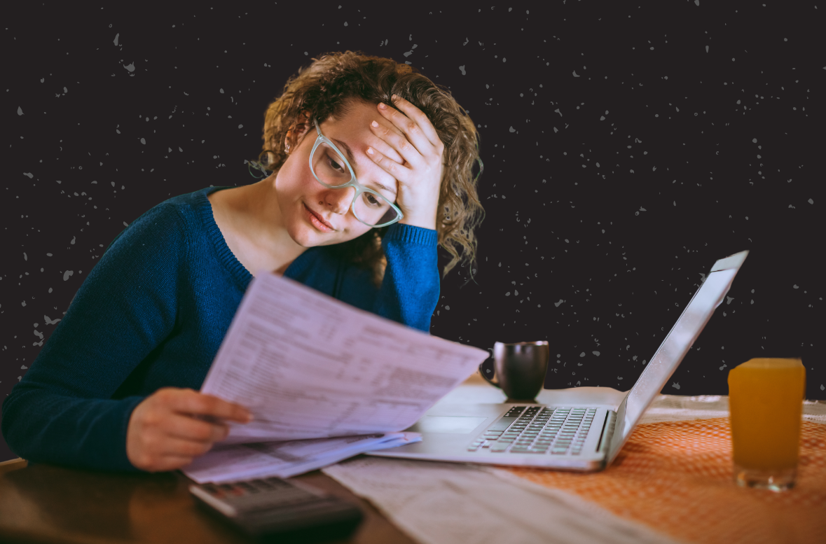 A photo illustration of a woman looking at a bill with her laptop in front of her.