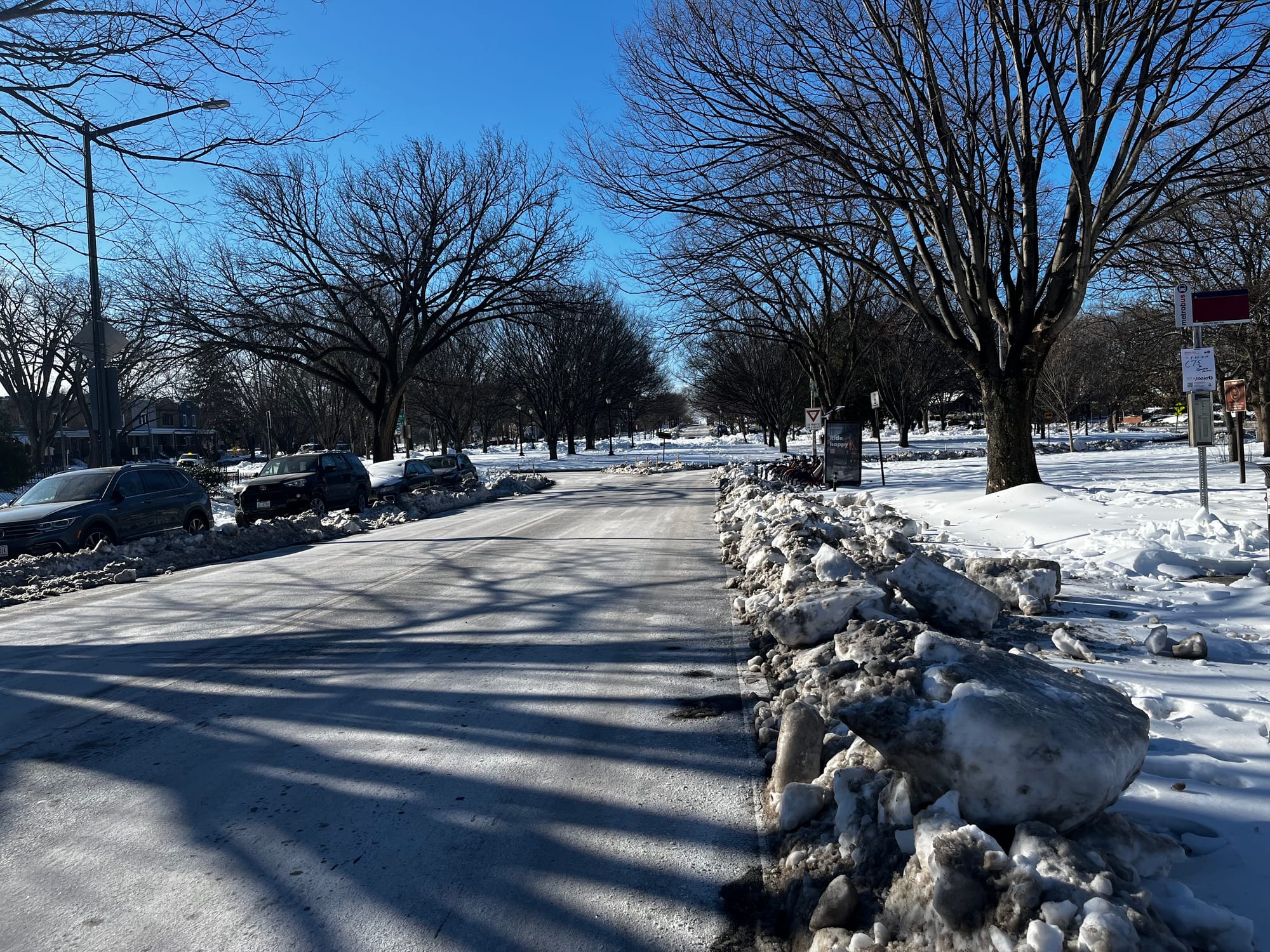Photo of a cleared rowed and snow-covered sidewalk.