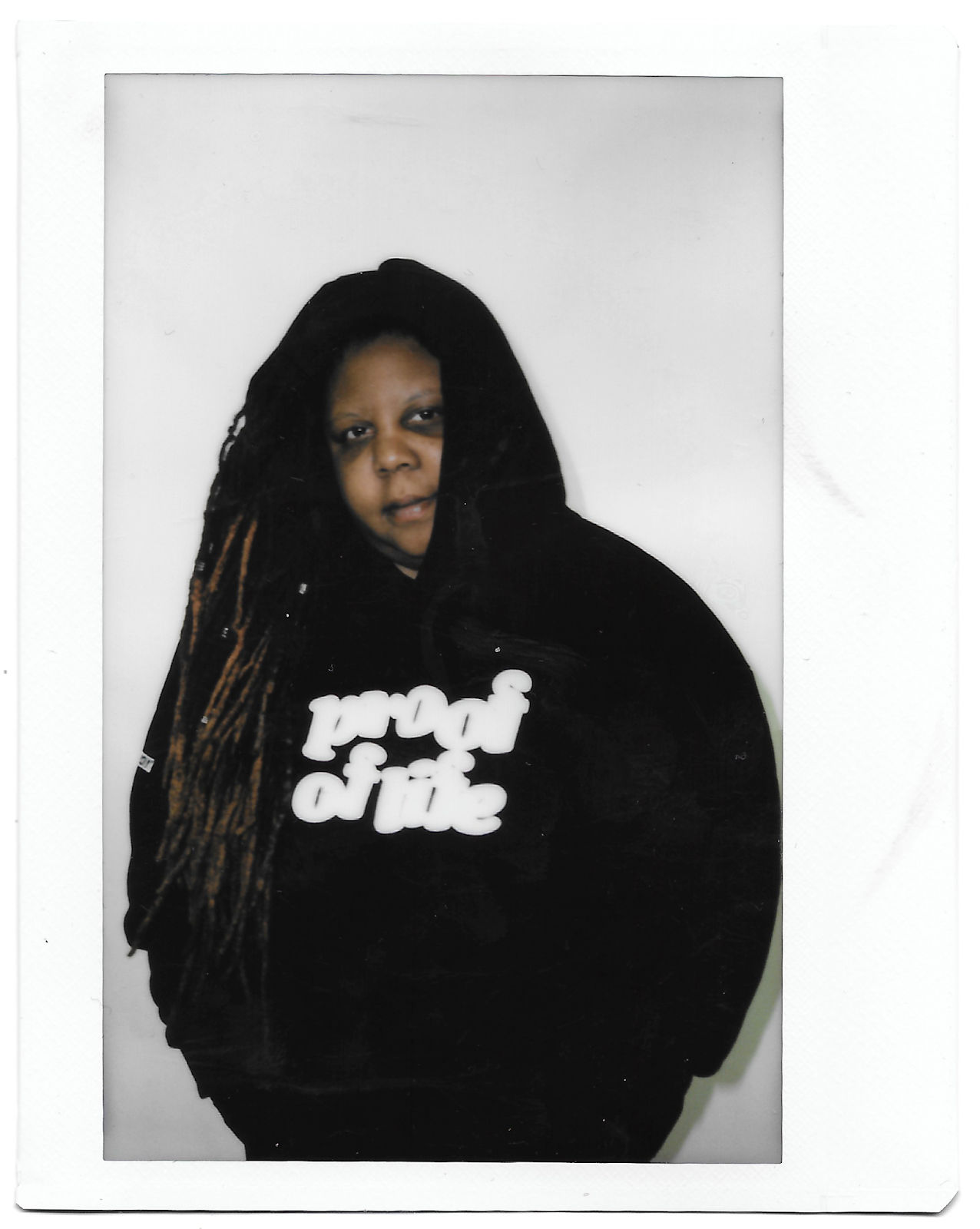 A portrait of Britnee Scott wearing a shirt that reads "Proof of Life."