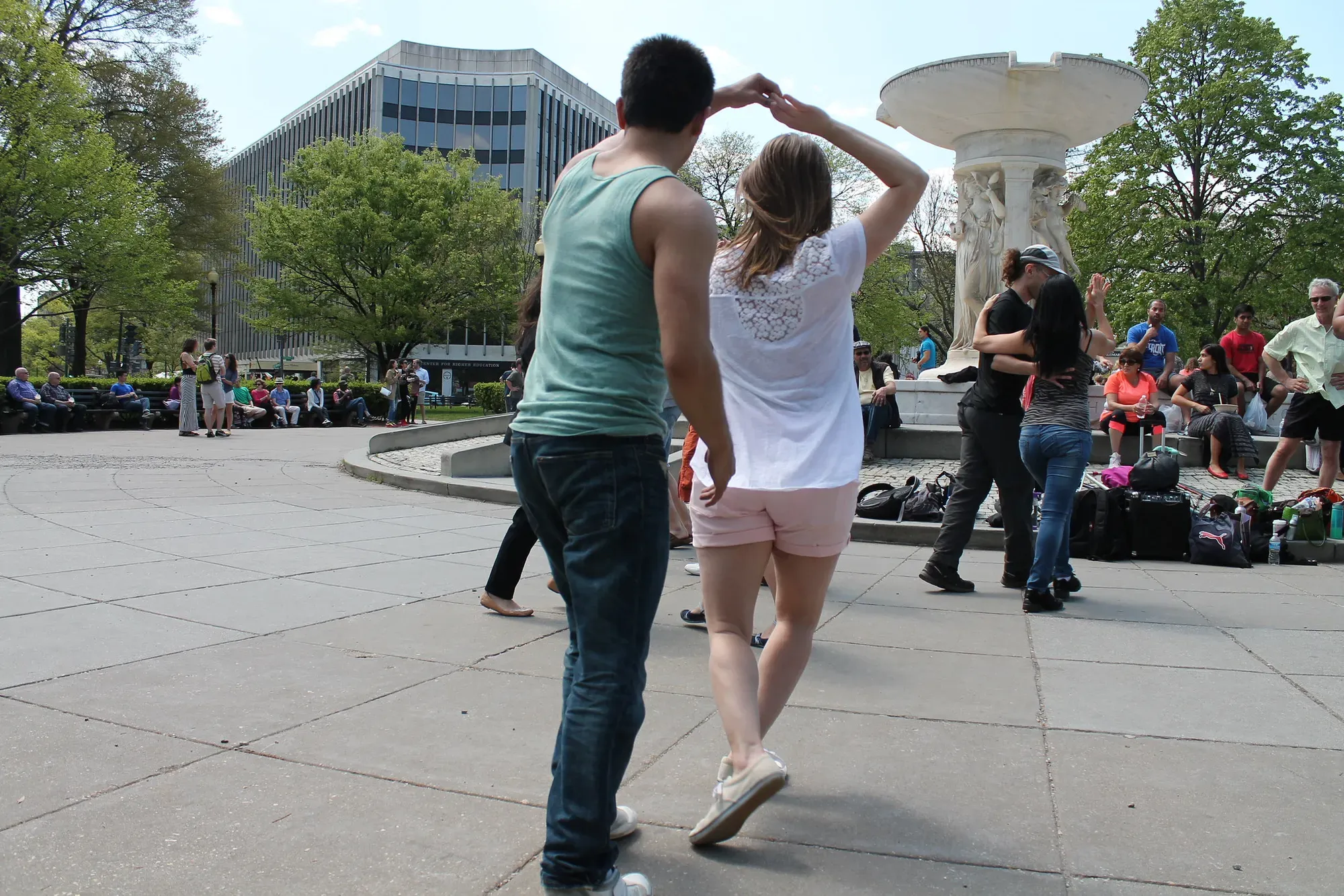 A couple dancing in a park.