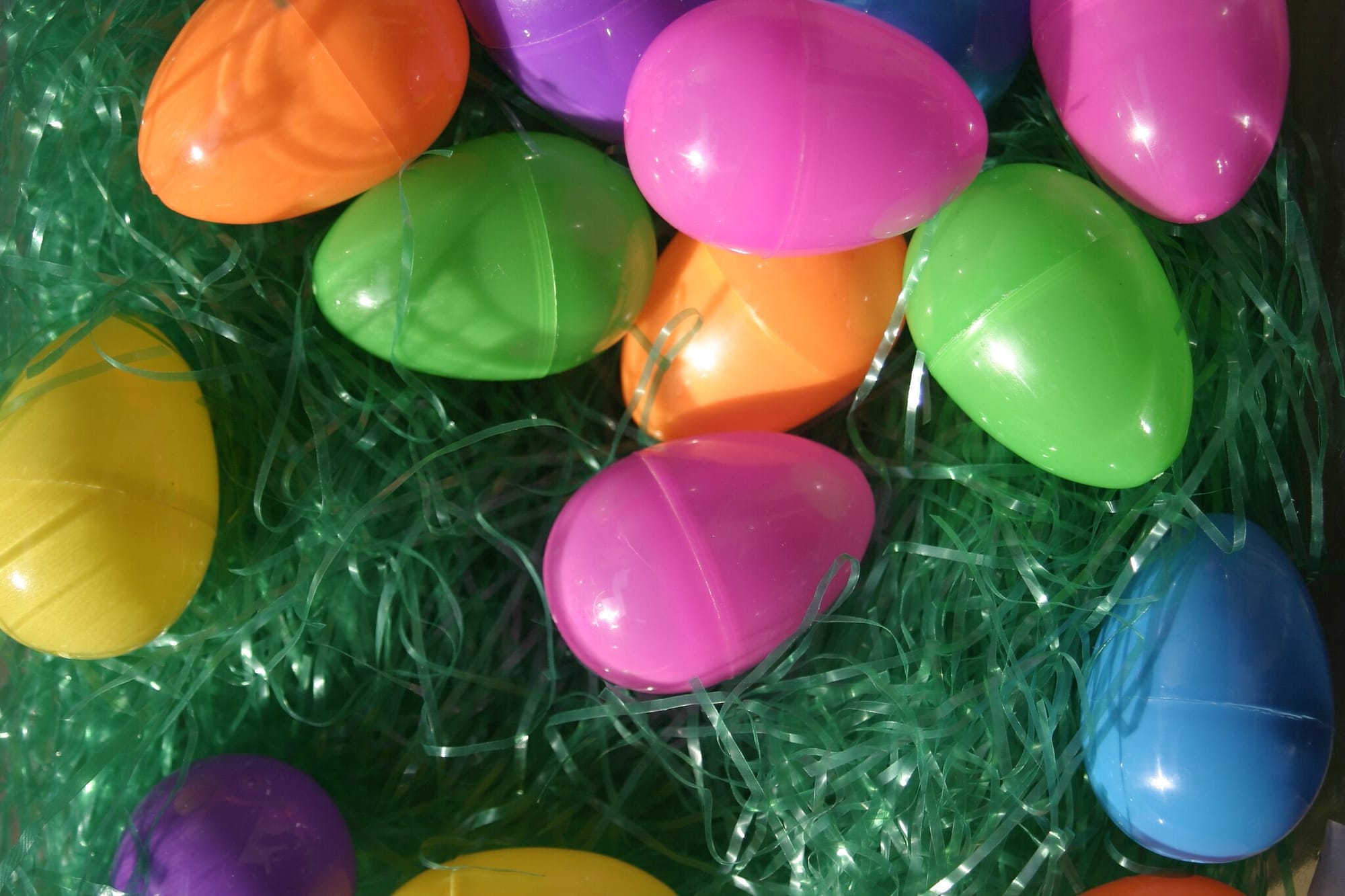 Colorful plastic Easter eggs on a bed of plastic grass