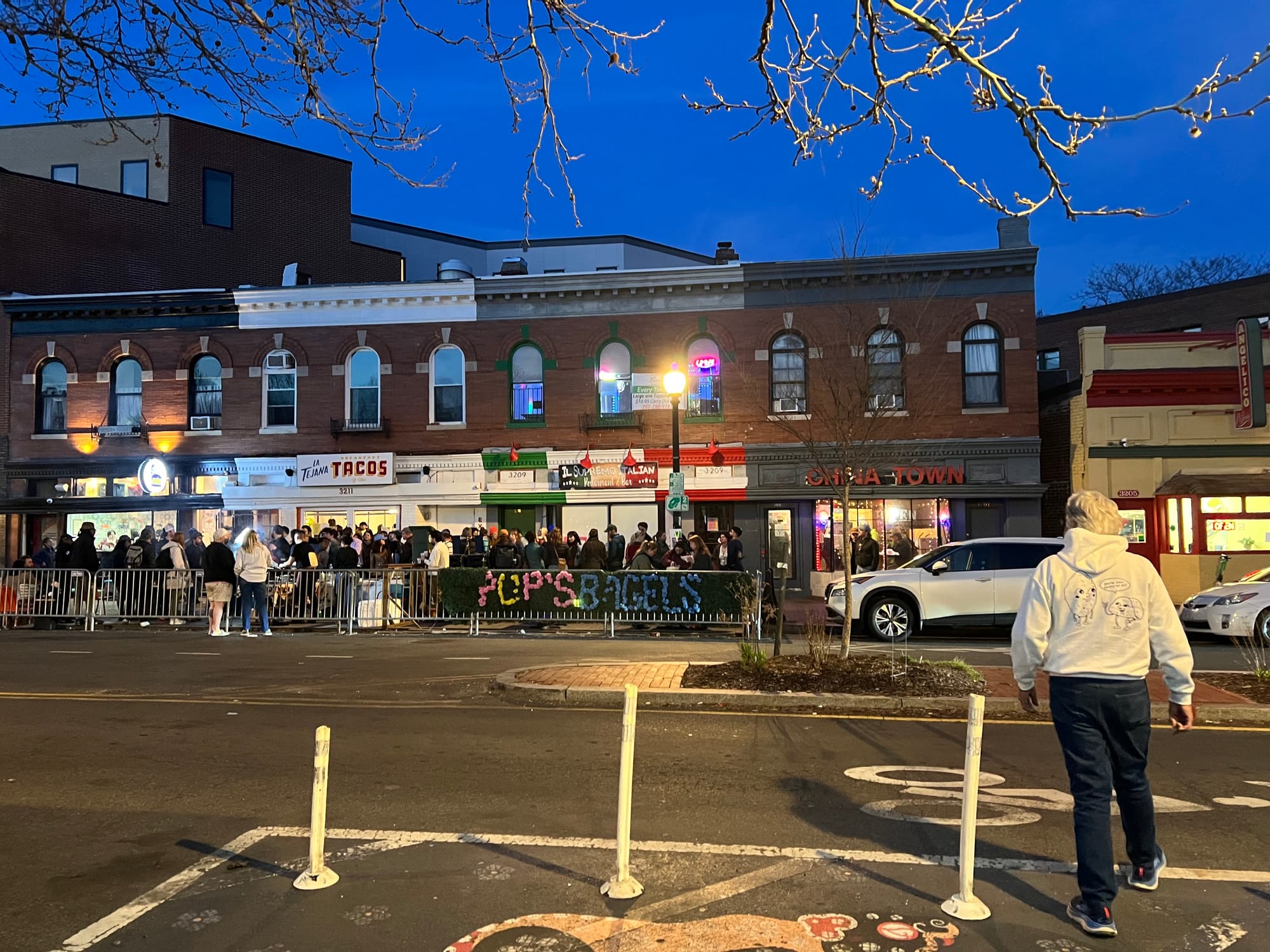A photo of the outside of La Tejana during their goodbye party for their streatery. Dozens of people stand outside.