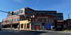Photo of an older building that reads Anacostia, in front of a newer brick development.
