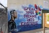 Mural of Black male looking toward text that says "Speak your dreams into existence."
