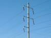 Electricity lines crisscross in the sky.