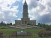 Exterior photo of the George Washington Masonic National Memorial sitting on a grassy hill.