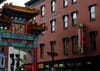 Chinatown arches slightly out of frame next to a red brick building.