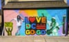 Colorful mural that says Love DC Go-Go with a man dancing on the left and Congress Heights Metro marker on the right