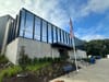 The outside of the Fort Dupont Ice Rink, which has large glass windows and an American flag out front.