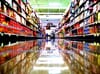 An empty supermarket aisle with shelves of food. 