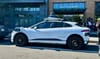 A white Waymo vehicle is parked on a D.C. street.