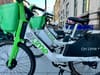 Lime bikes wait for riders on a D.C. sidewalk.
