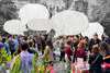 A collage that shows a crowd of 51st readers standing around outside with speech bubbles above them. 