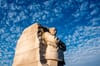 The Martin Luther King Jr. Memorial in Washington D.C. against a blue sky. 