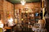 A brick room full of vintage furniture and knickknacks.