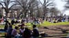 A photo of hundreds of people on the grass of Malcolm X Park. 