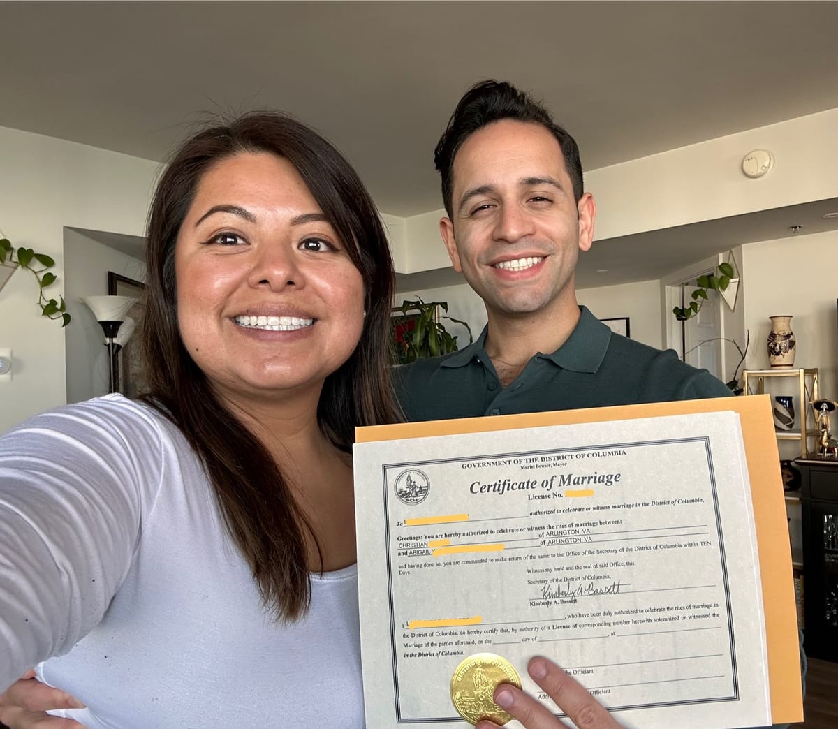 Two people hold a marriage license issued by the District of Columbia. 