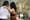 A couple dancing in the park, facing away from the camera.