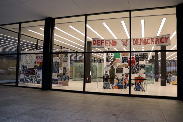 A view of the BLM Fence exhibit in the MLK Memorial Library through a window.