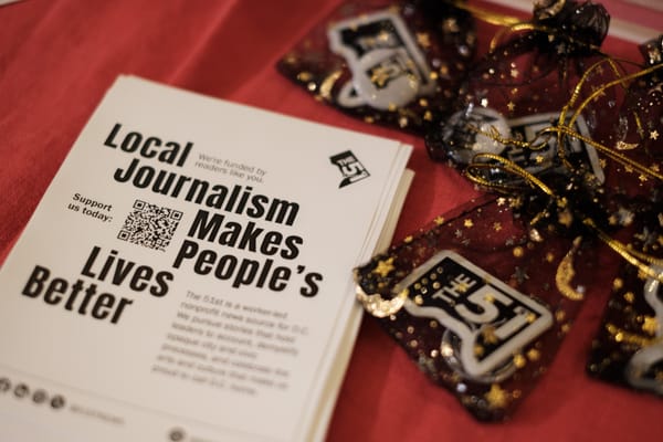 A flyer that reads 'Local Journalism Makes People's Lives Better' and goodie bags with 51st stickers and buttons. 