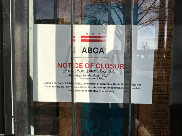 A photograph of a sign outside a weed store named Happy Bud that reads: "Notice of Closure."